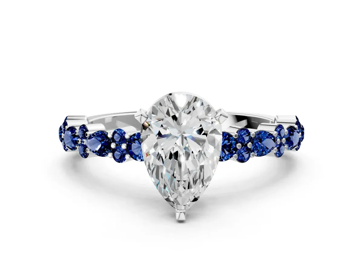 Pear Cut Diamond Side Stone Solitaire Ring with Round Blue Sapphire and Four-Prong Setting Platinum