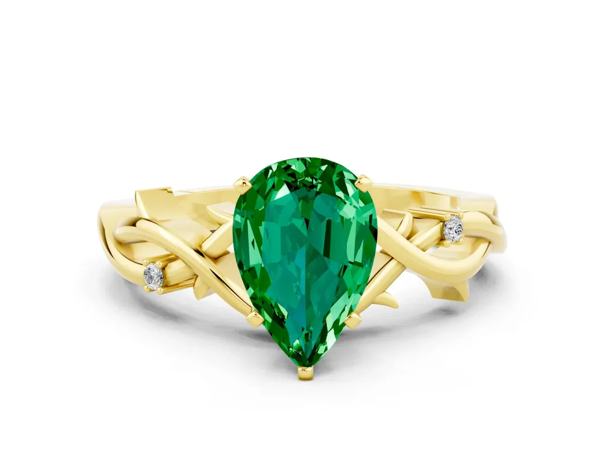 Pear Cut Emerald Solitaire Ring with Twisted Band and Prong Setting Yellow gold