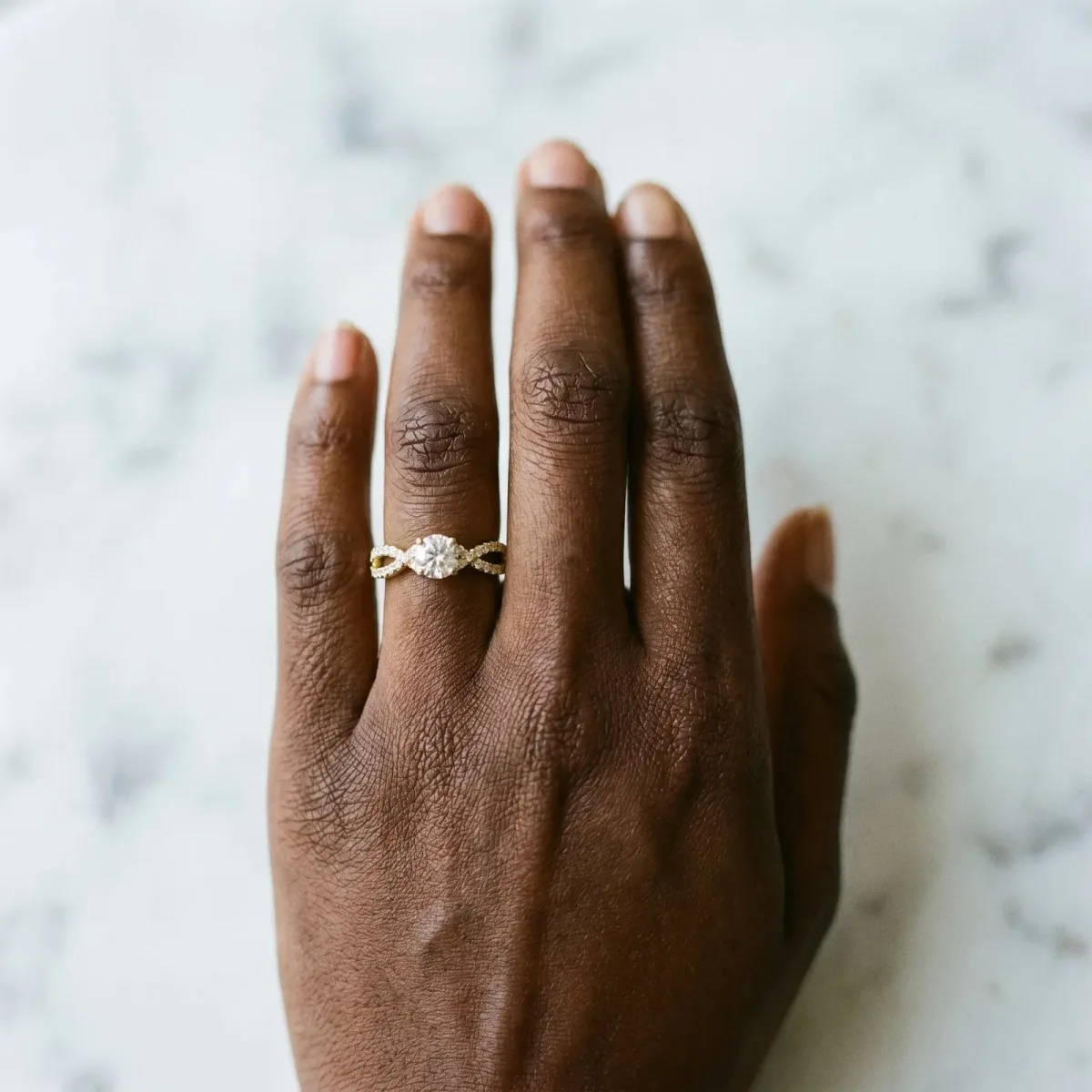 Pavé Round Diamond Infinity Twist Band with Shared Prong Setting Yellow gold