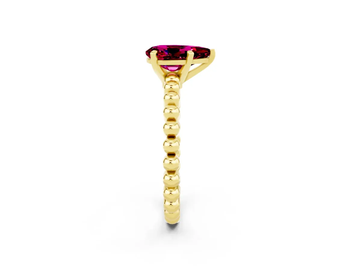 Pear Cut Garnet Solitaire Ring with Beaded Band and Prong Setting Yellow gold