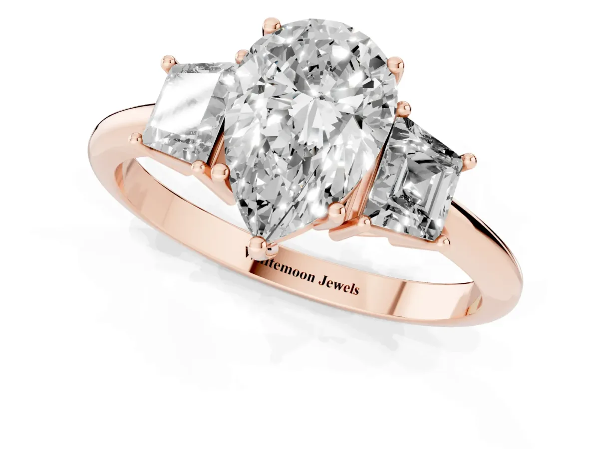 Pear Cut Diamond Three-Stone Ring with Trapezoid Side Stones and Prong Setting Rose gold