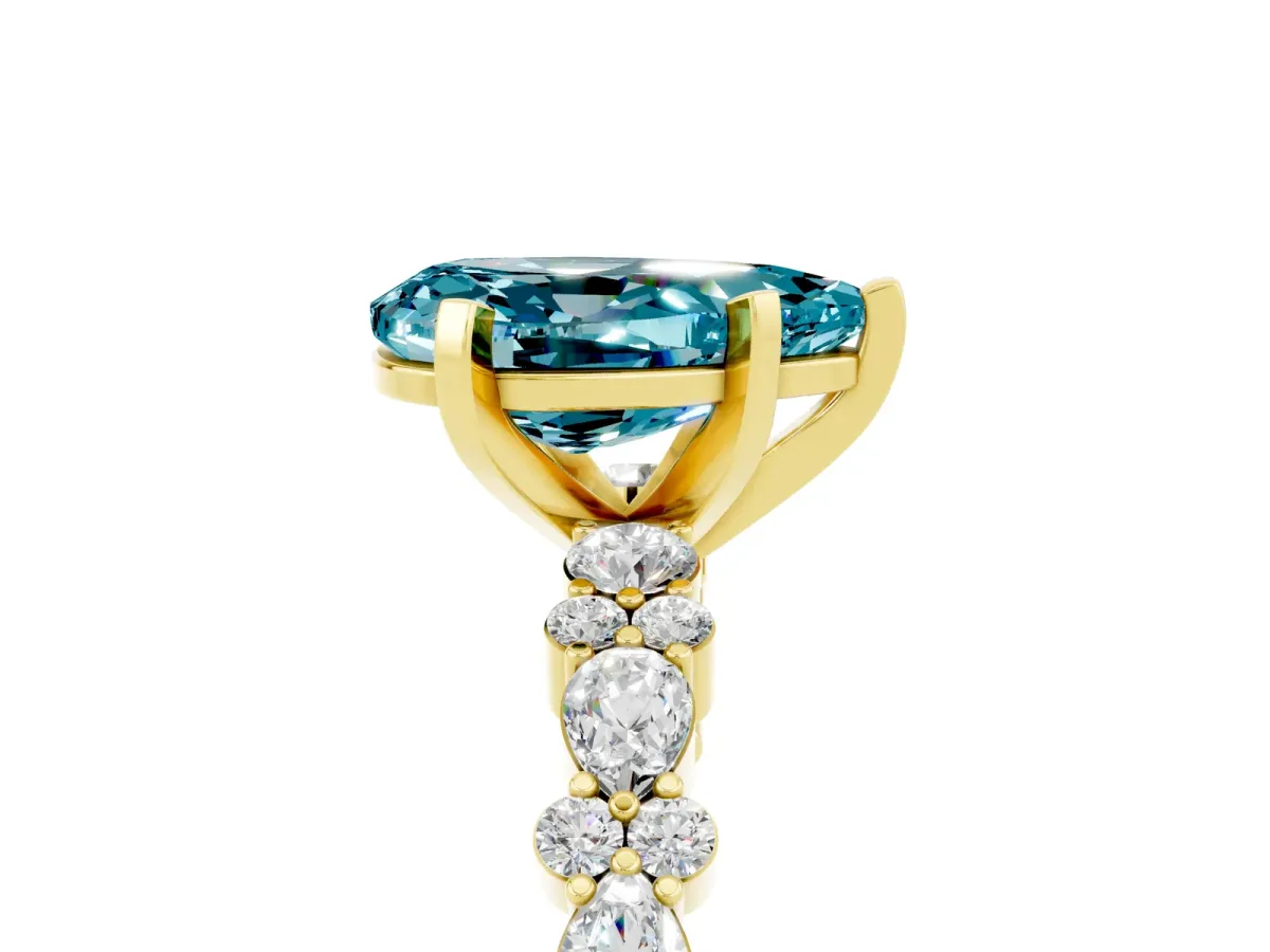 Pear Cut Blue Topaz Side Stone Solitaire Ring with Round and Four-Prong Setting Yellow gold
