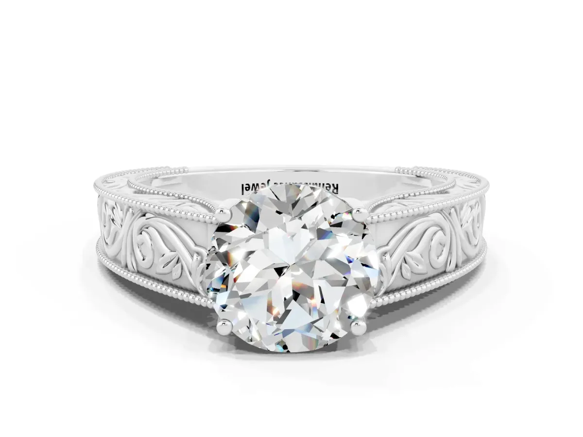 Round Cut Moissanite Solitaire Ring with Engraved Band and Four-Prong Setting White gold