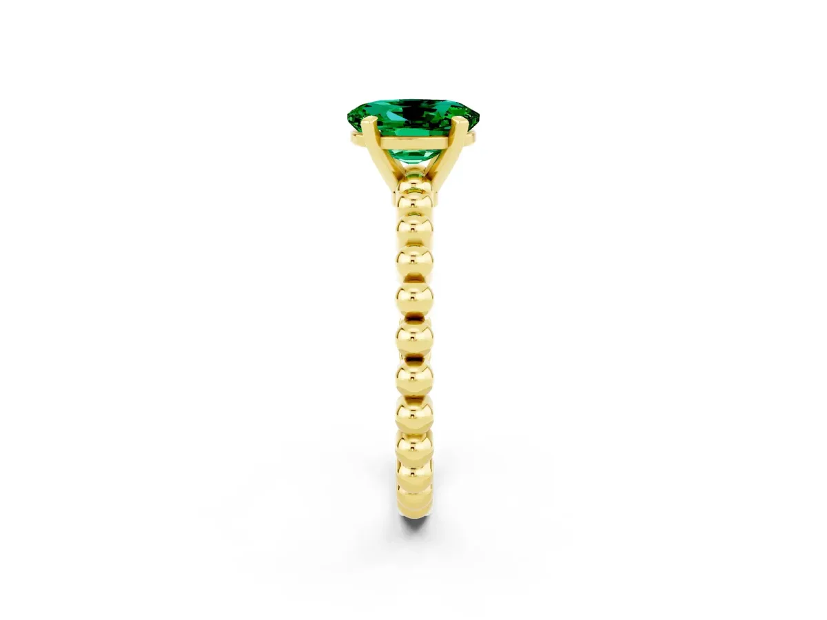Oval Cut Emerald Solitaire Ring with Beaded Band and Prong Setting Yellow gold