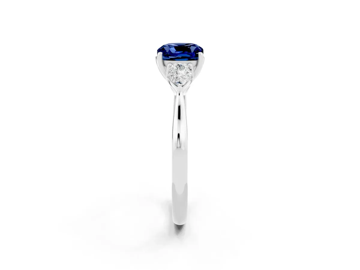 Three-Stone Cushion Cut Blue Sapphire Ring with Pear Side Stones in Four-Prong Setting White gold