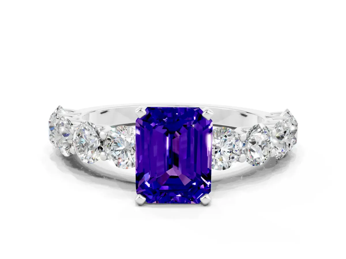 Emerald Cut Tanzanite Prong Setting with Side Stones on a Pave Band Platinum