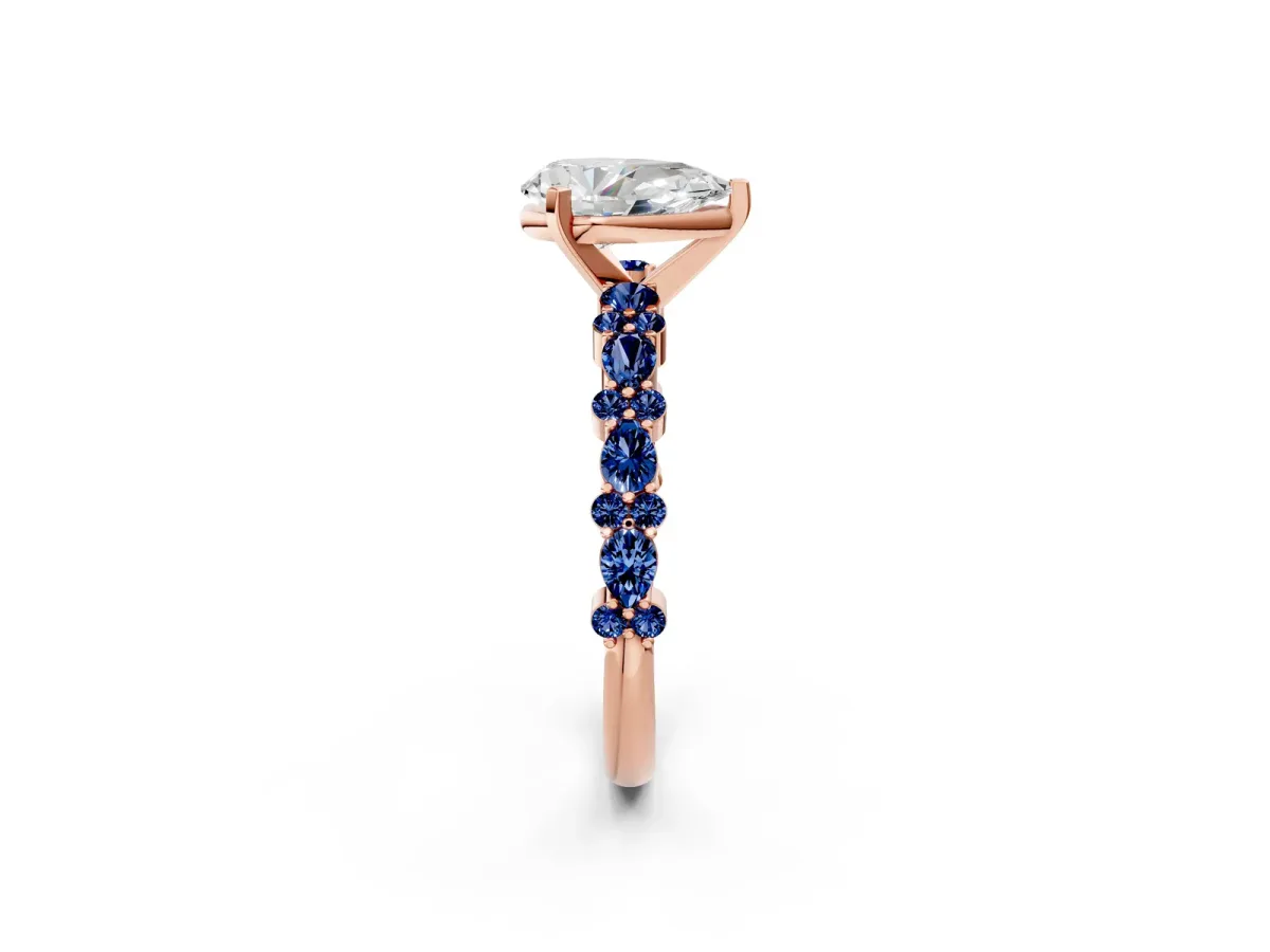 Pear Cut Diamond Side Stone Solitaire Ring with Round Blue Sapphire and Four-Prong Setting Rose gold
