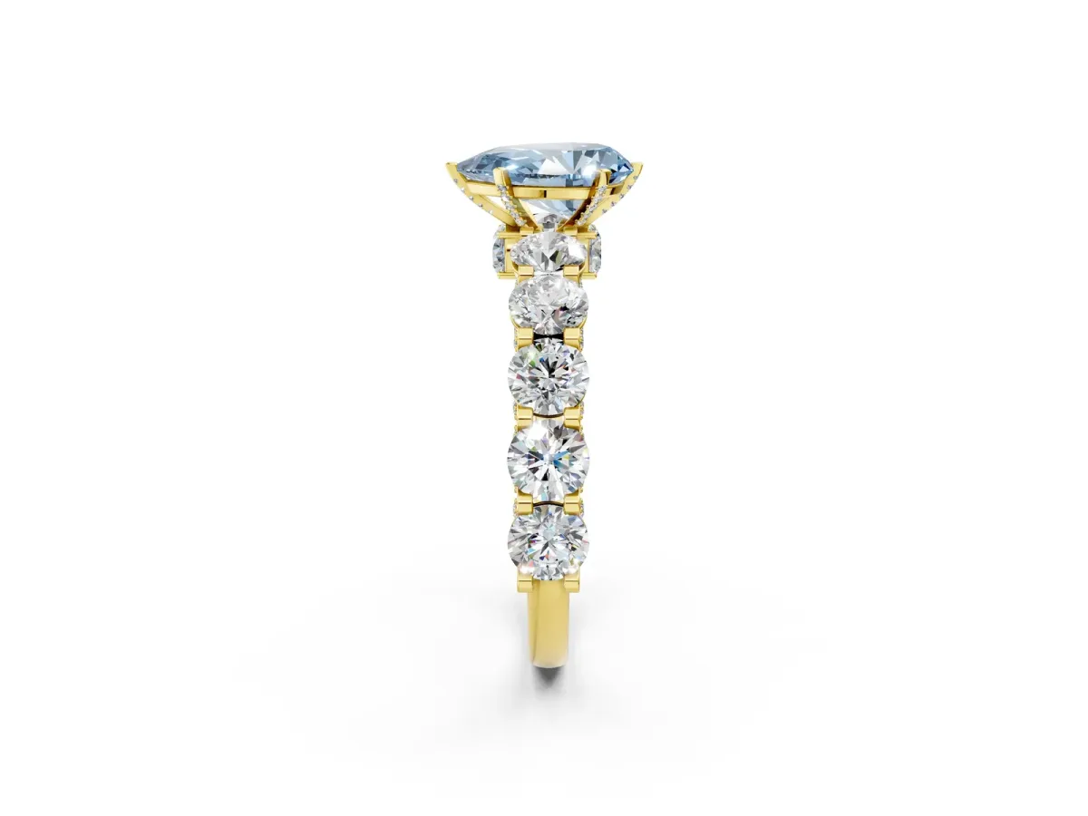 Fancy Blue Pear Cut Diamond Side Stone Engagement Ring with Four-Prong Setting Yellow gold