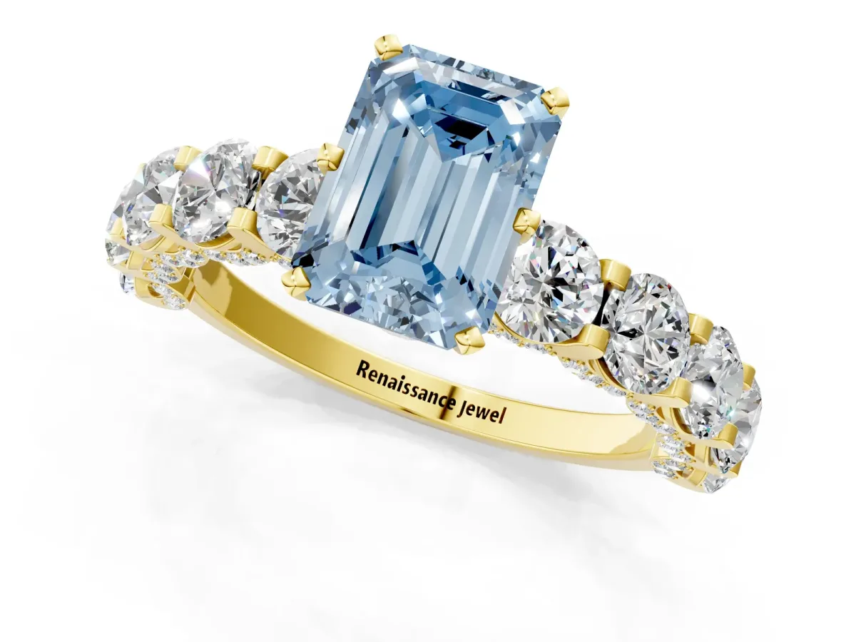 Fancy Blue Emerald Cut Diamond Side Stone Engagement Ring with Four-Prong Setting Yellow gold