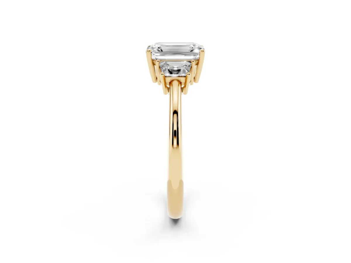 Emerald Cut Diamond Three-Stone Ring with Trapezoid Side Stones and Prong Setting Yellow gold
