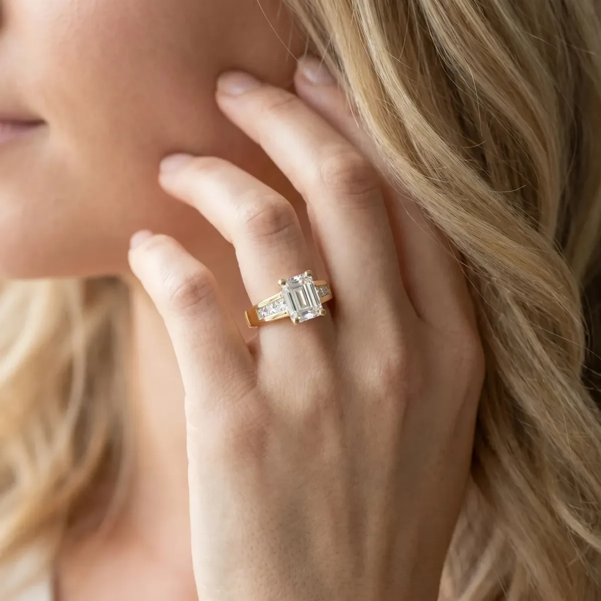 Emerald Cut Cut Channel Set Solitaire Ring with Four-Prong Setting Yellow gold