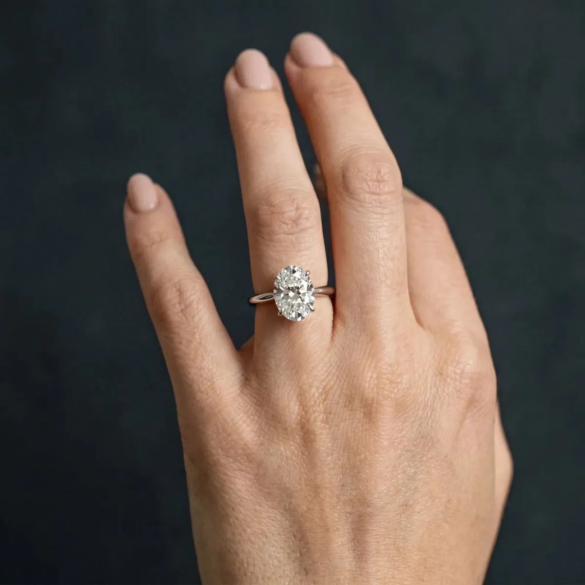 Oval Cut Diamond Solitaire Engagement Ring with Classic Band and Four-Prong Setting Silver