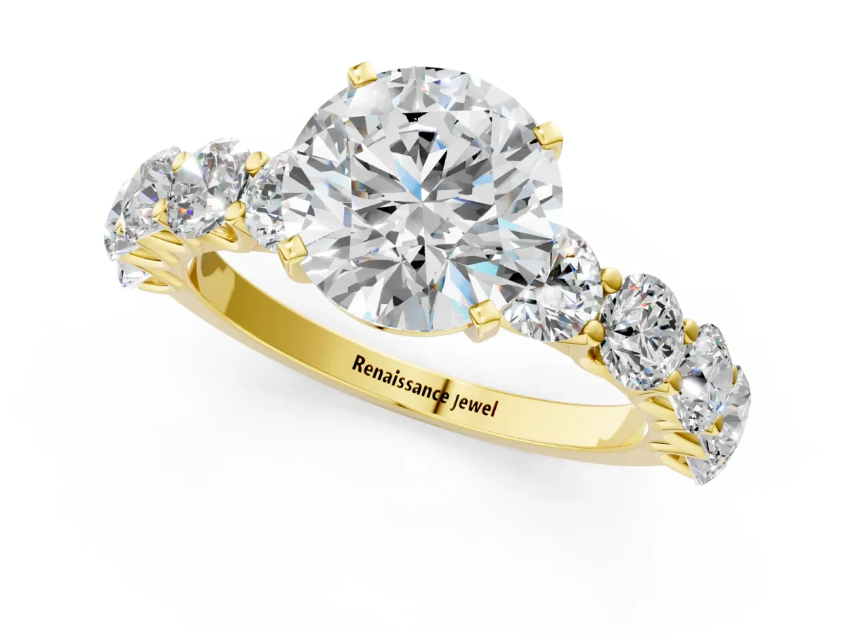 Round Cut Diamond Prong Setting with Side Stones on a Pave Band Yellow gold