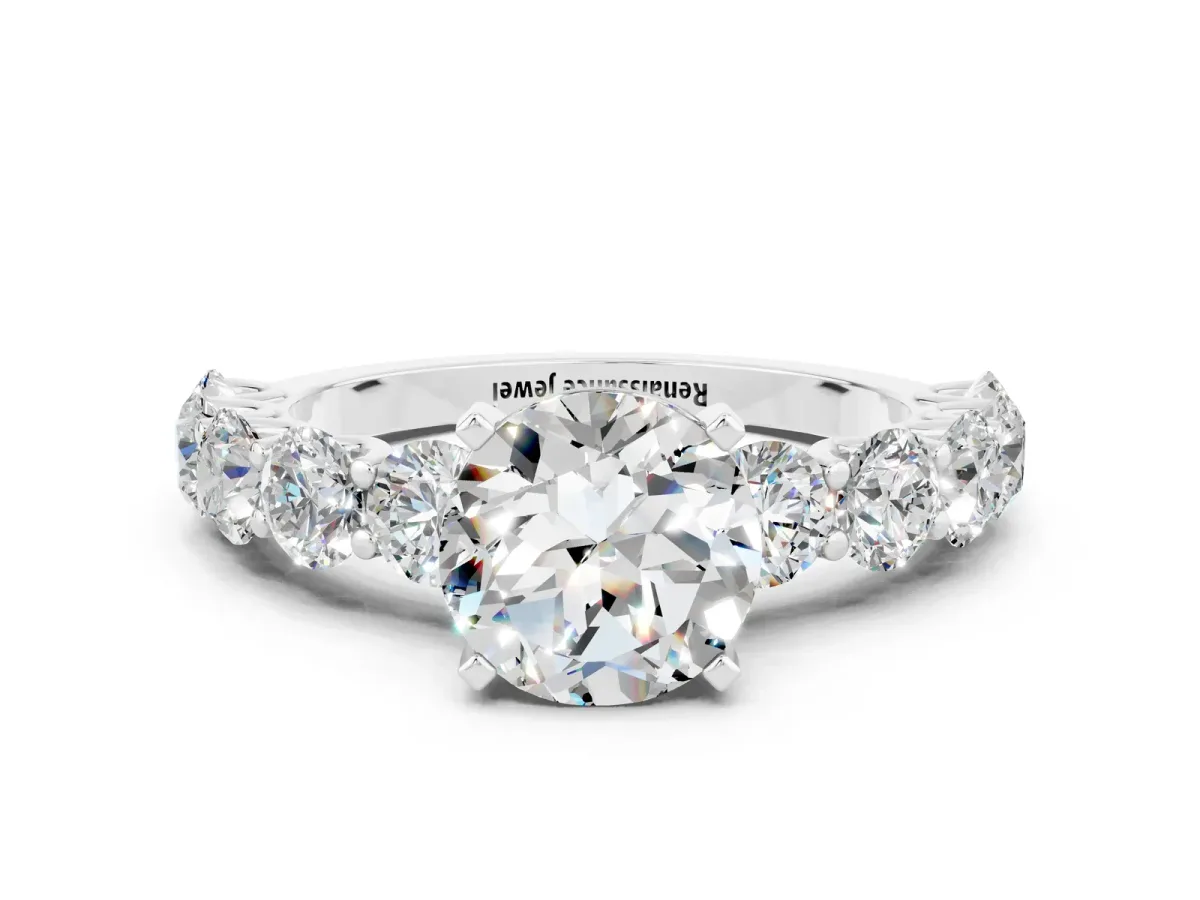 Round Cut Moissanite Prong Setting with Side Stones on a Pave Band Silver
