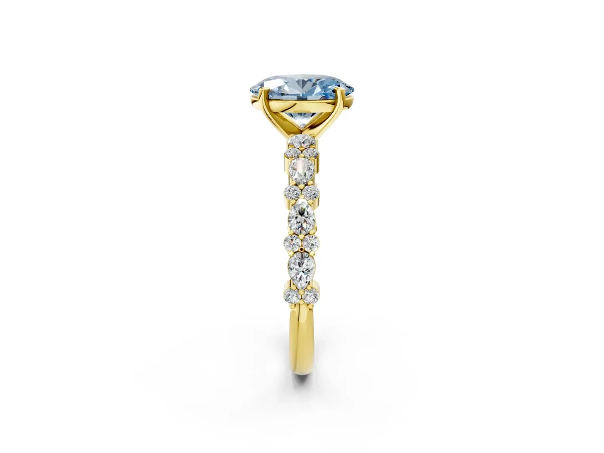 Fancy Blue Oval Cut Diamond Side Stone Solitaire Ring with Round and Four-Prong Setting Yellow gold