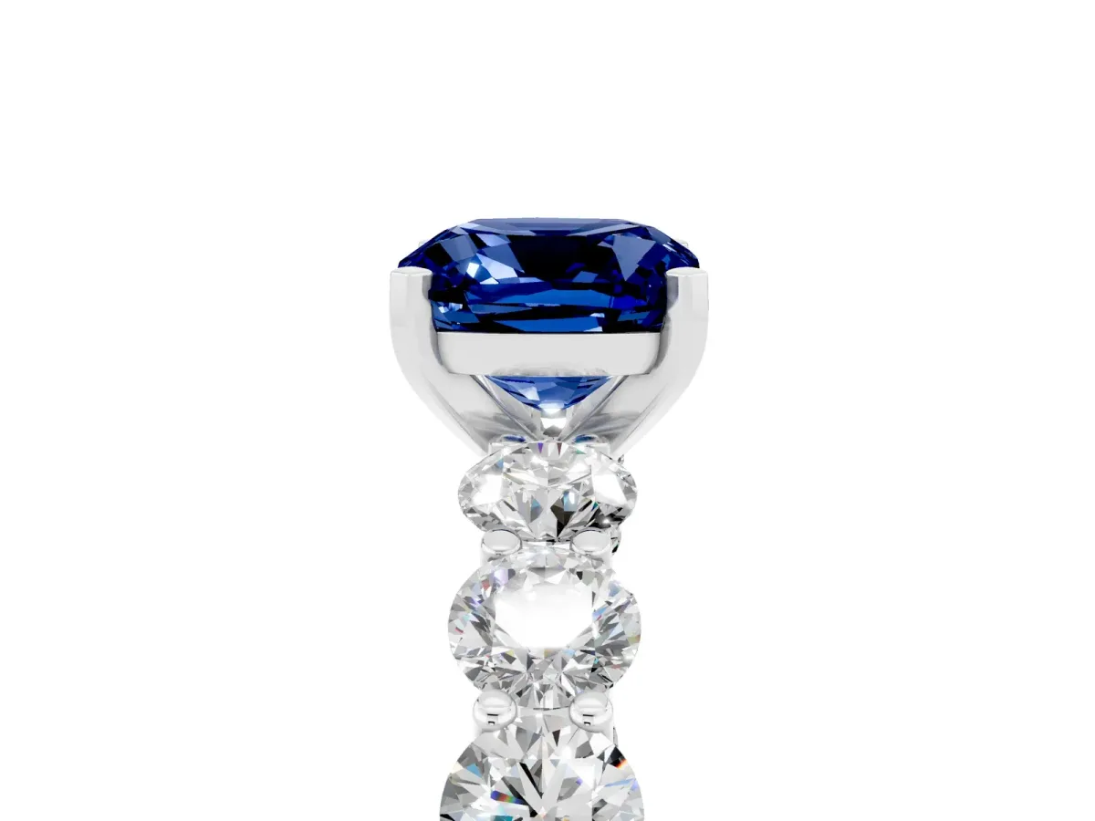 Cushion Cut Blue Sapphire Prong Setting with Side Stones on a Pave Band Silver