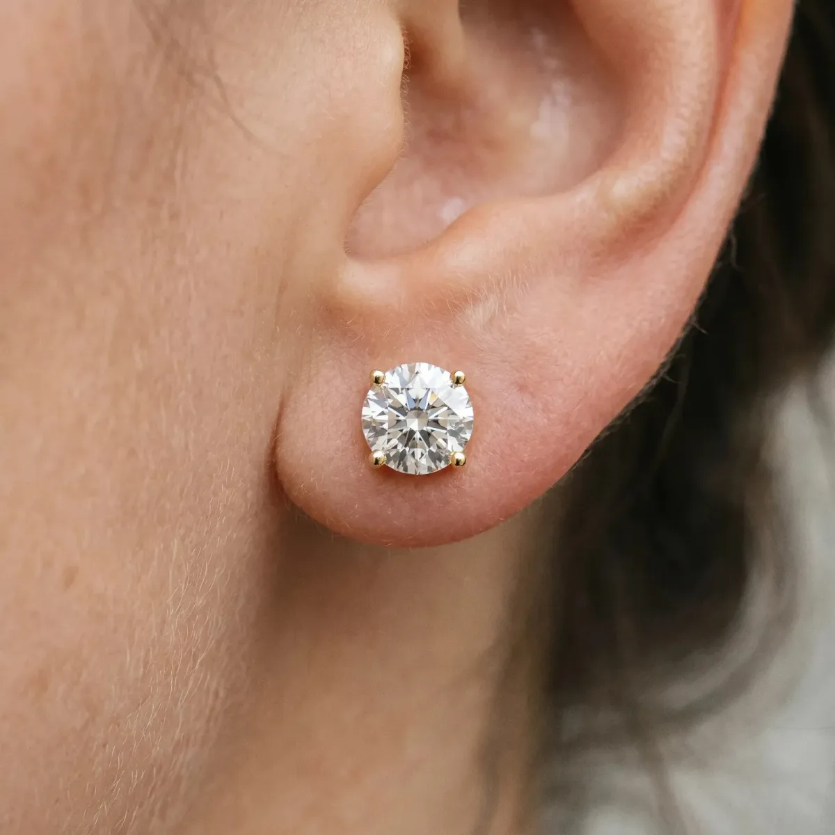 Round Solitaire Diamond Stud Earrings with Four-Prong Basket Setting Yellow gold
