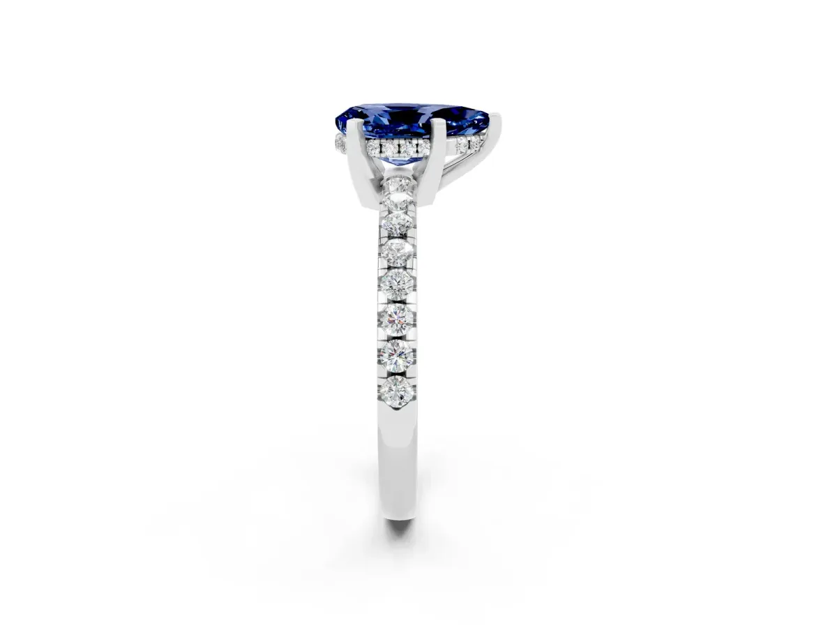 Pear Cut Blue Sapphire Solitaire Ring with Round Pavé Band and Four-Prong Setting Silver