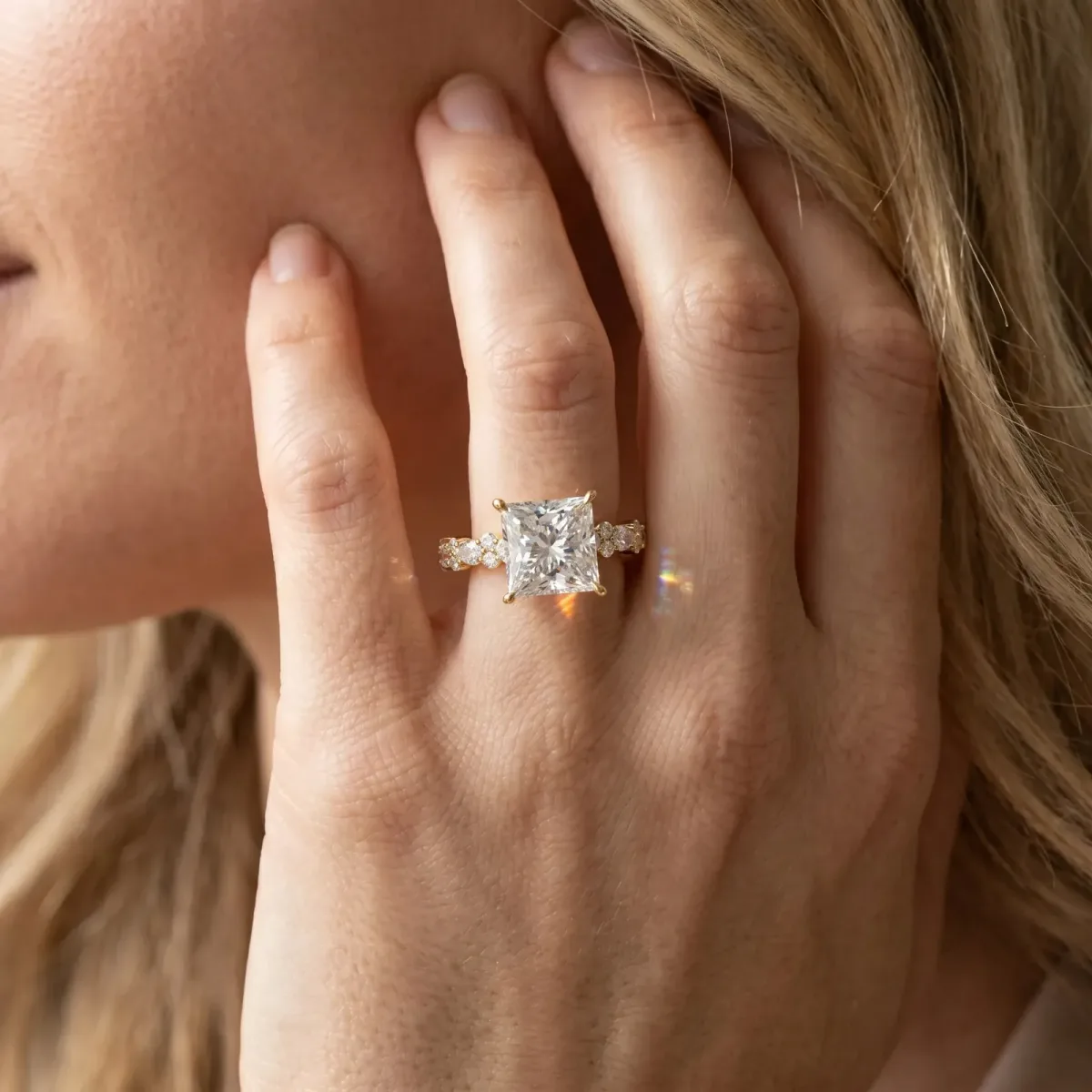 Princess Cut Diamond Side Stone Solitaire Ring with Round and Four-Prong Setting Yellow gold