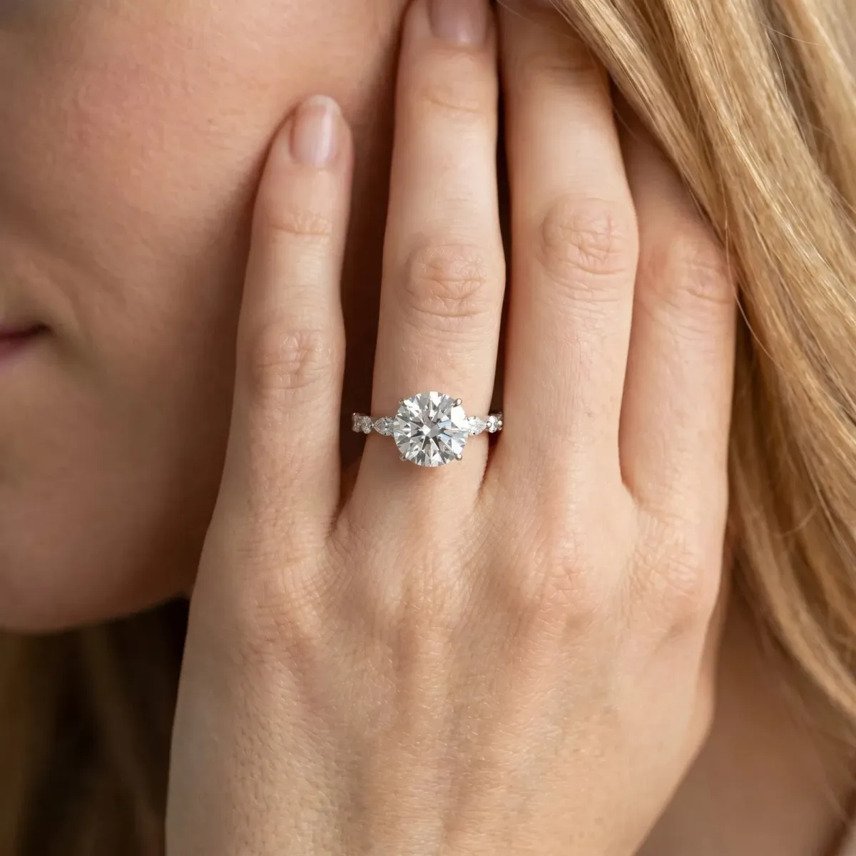 Round Cut Diamond Ring with Marquise and Round Side Stones and Four-Prong Setting Silver