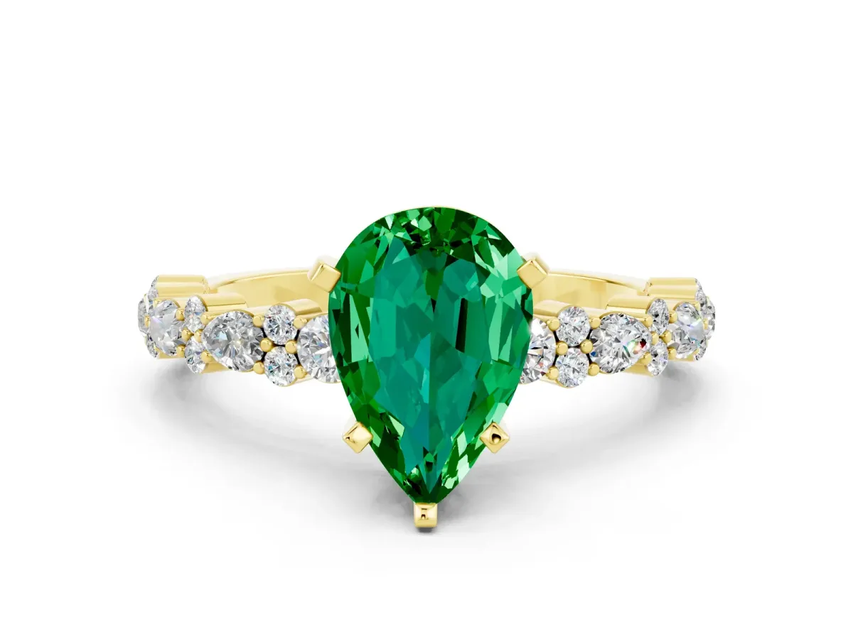 Pear Cut Emerald Side Stone Solitaire Ring with Round and Four-Prong Setting Yellow gold