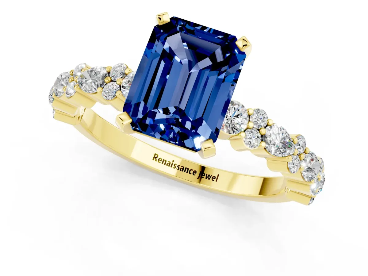 Emerald Cut Blue Sapphire Side Stone Solitaire Ring with Round and Four-Prong Setting Yellow gold