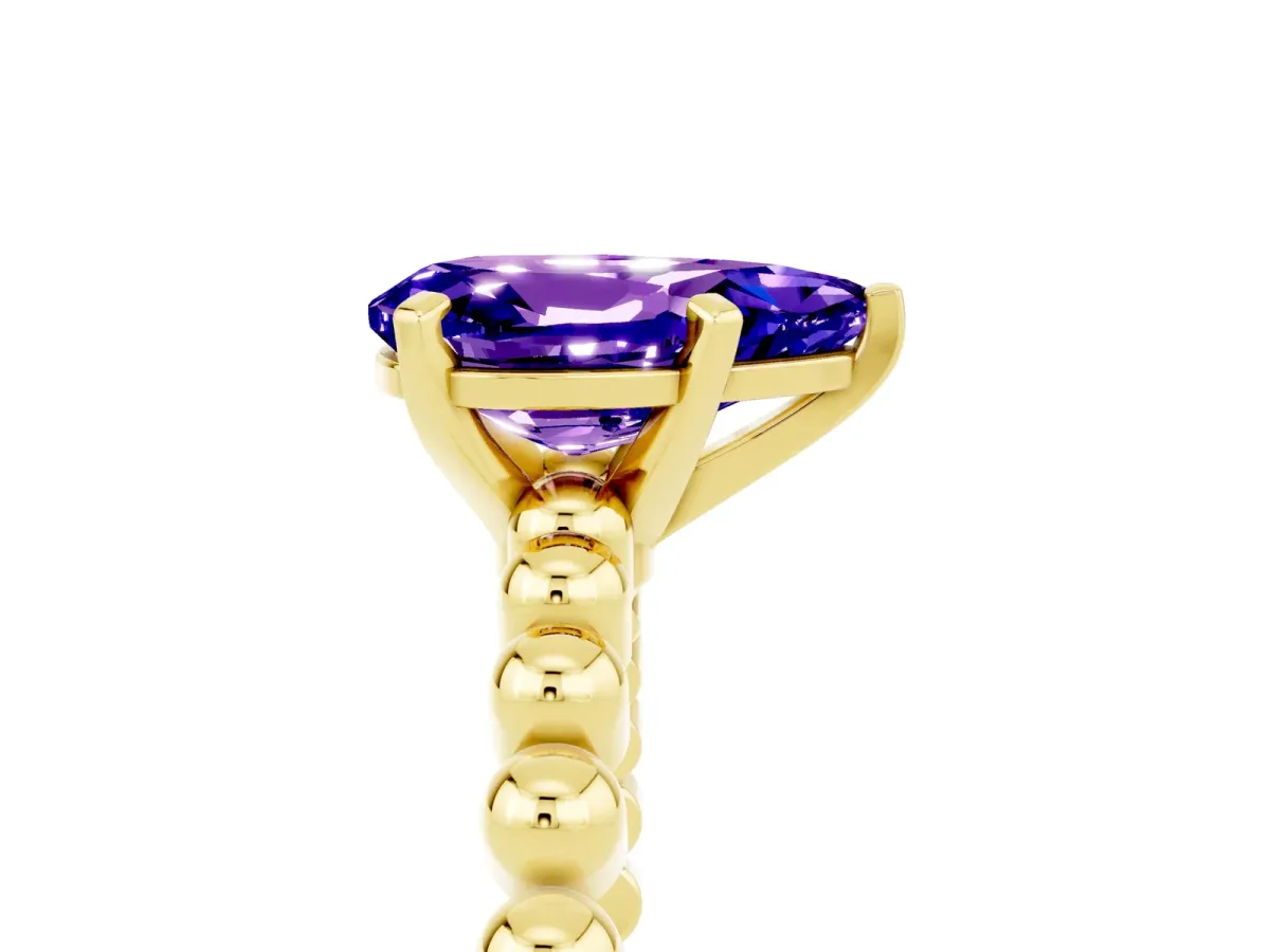 Pear Cut Tanzanite Solitaire Ring with Beaded Band and Prong Setting Yellow gold
