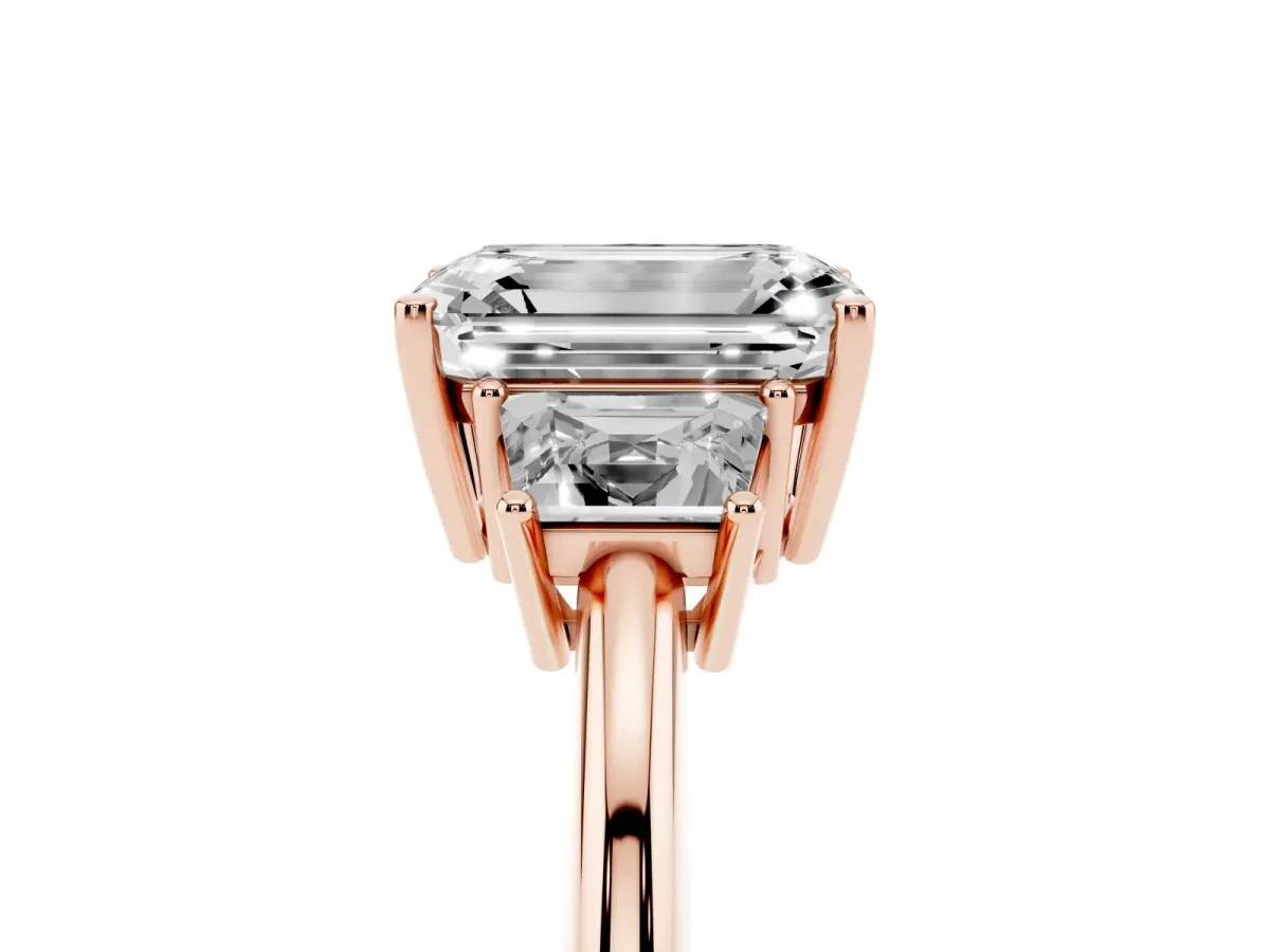 Emerald Cut Diamond Three-Stone Ring with Trapezoid Side Stones and Prong Setting Rose gold