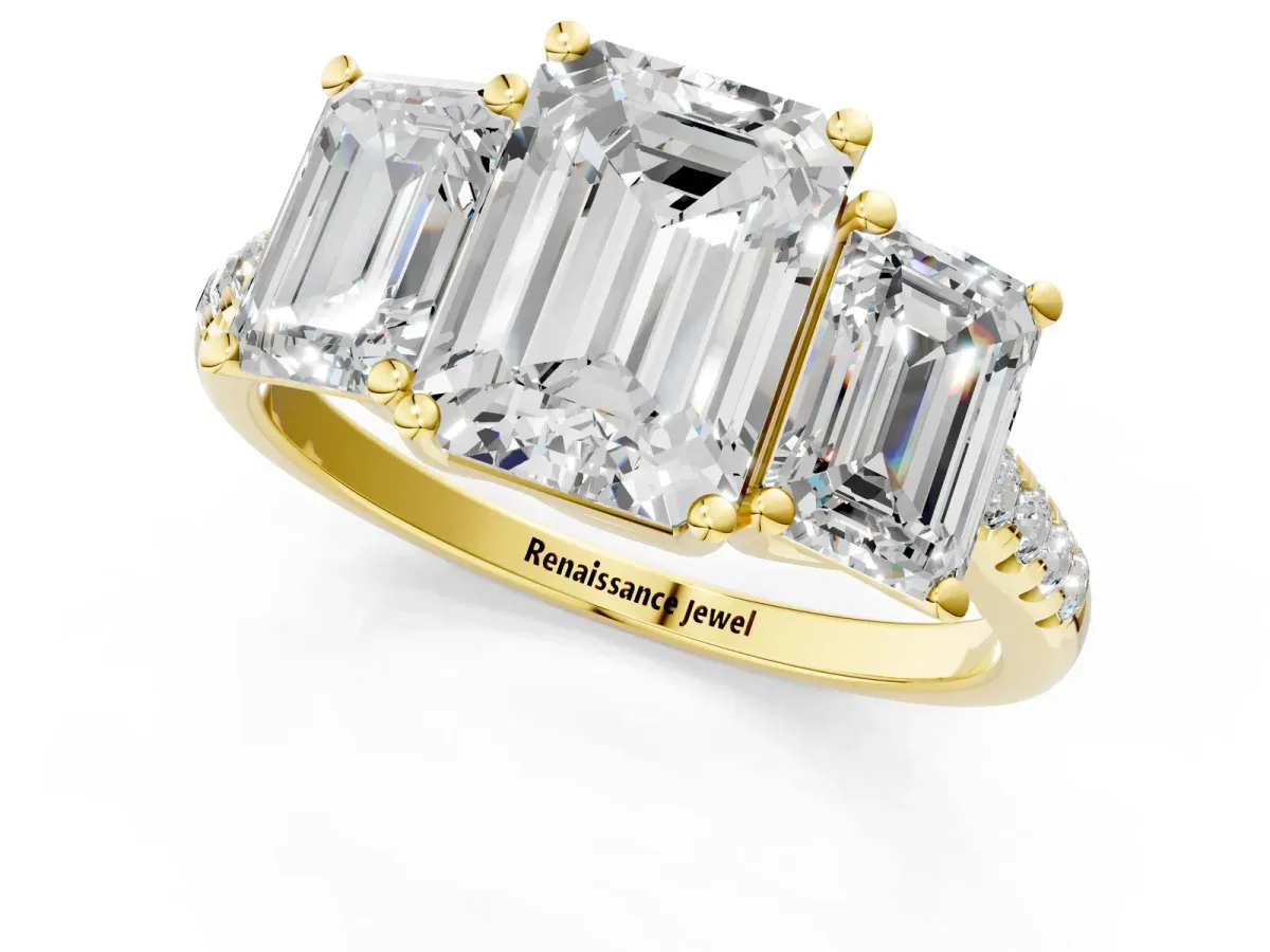 Three-Stone Emerald Cut Diamond Ring with Round Pavé Band and Prong Setting Yellow gold
