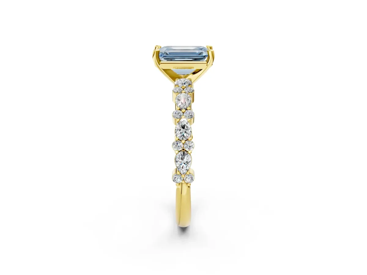 Fancy Blue Emerald Cut Diamond Side Stone Solitaire Ring with Round and Four-Prong Setting Yellow gold