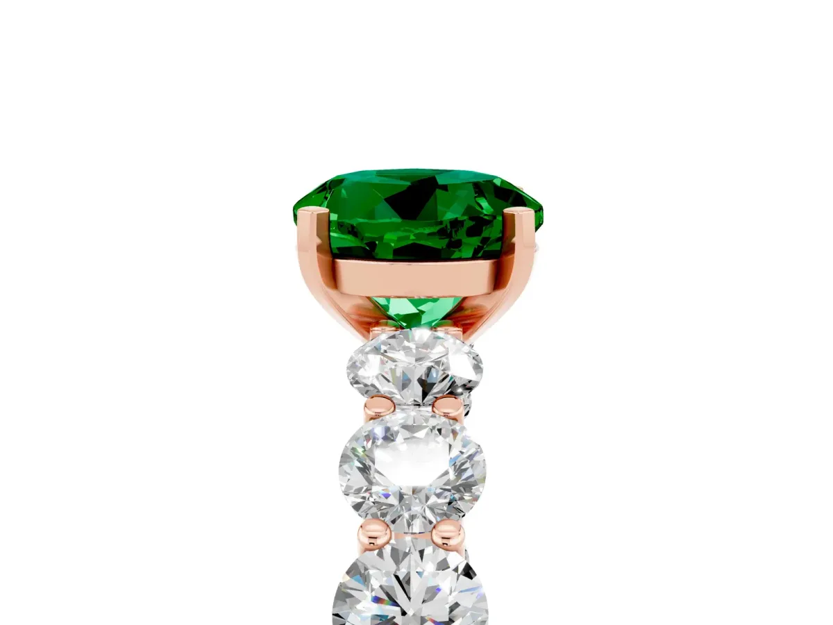 Round Cut Emerald Prong Setting with Side Stones on a Pave Band Rose gold