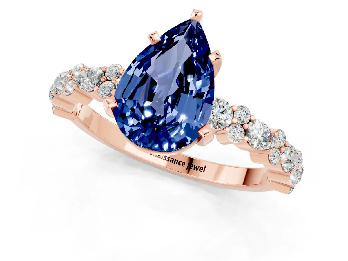 Pear Cut Blue Sapphire Side Stone Solitaire Ring with Round and Four-Prong Setting Rose gold