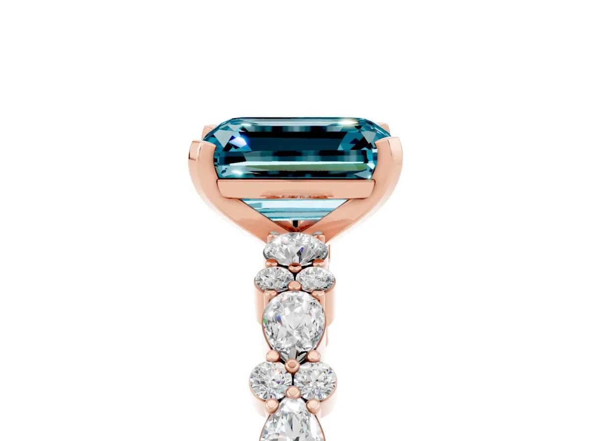 Emerald Cut Blue Topaz Side Stone Solitaire Ring with Round and Four-Prong Setting Rose gold