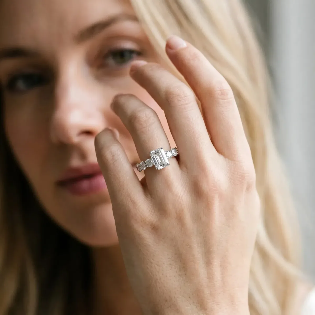 Emerald Cut Diamond Prong Setting with Side Stones on a Pave Band Platinum