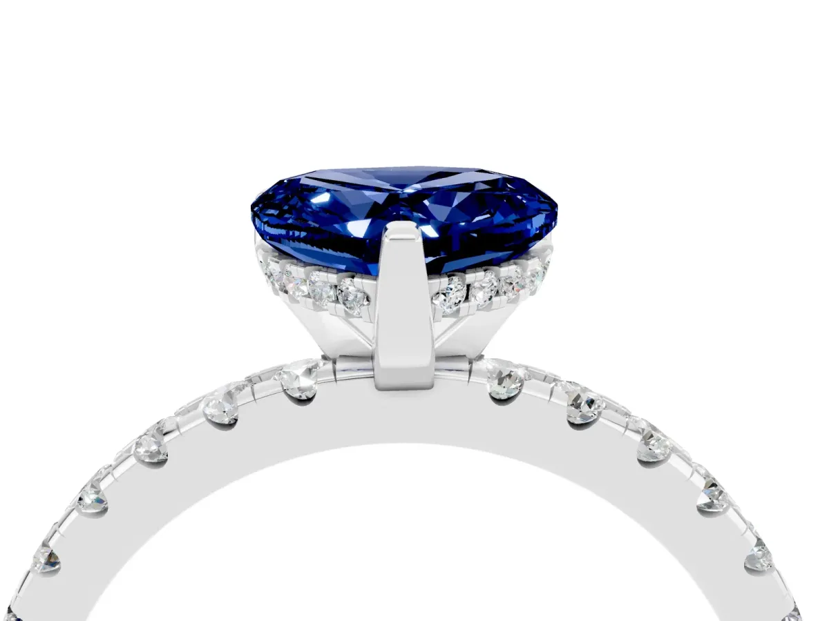 Heart Cut Blue Sapphire Solitaire Ring with Round Pavé Band and Four-Prong Setting Silver