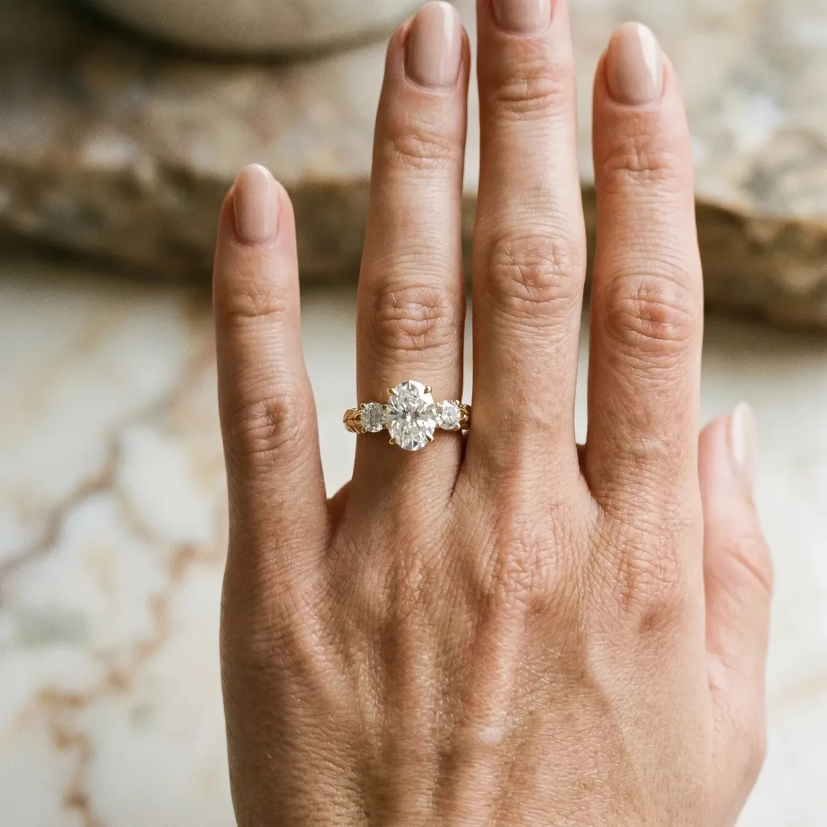 Three-Stone Oval Cut Cut Diamond Ring with Channel-Set Band and Prong Setting Yellow gold