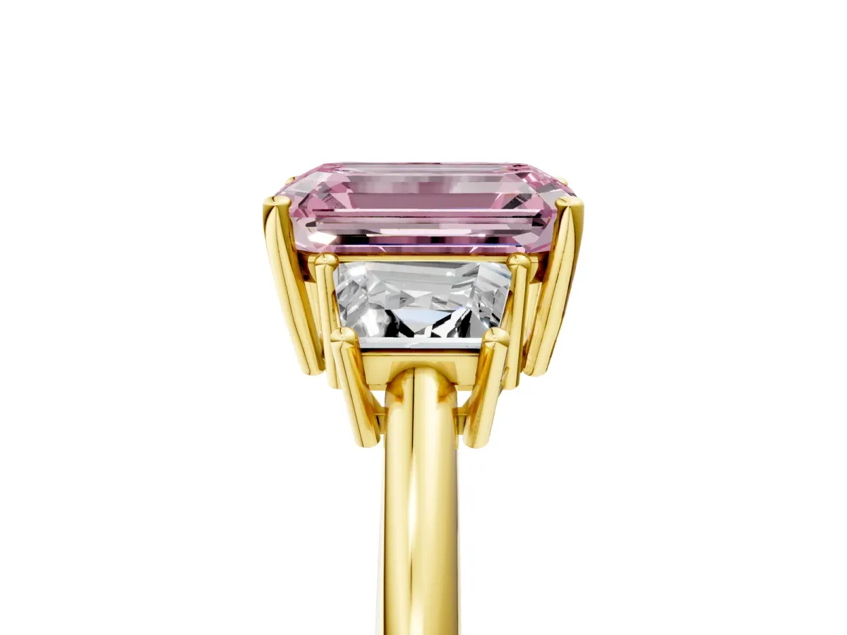 Fancy Pink Emerald Cut Diamond Three-Stone Ring with Trapezoid Side Stones and Prong Setting Yellow gold