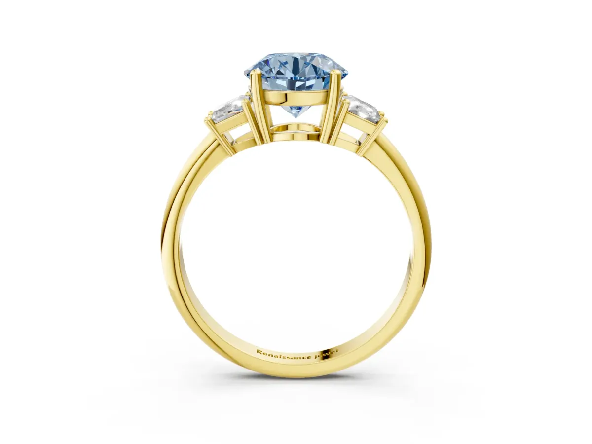Fancy Blue Round Cut Diamond Three-Stone Ring with Trapezoid Side Stones and Prong Setting Yellow gold