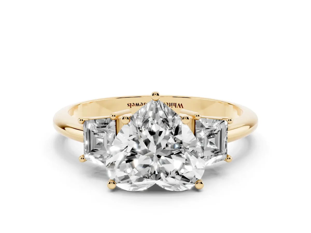 Heart Cut Diamond Three-Stone Ring with Trapezoid Side Stones and Prong Setting Yellow gold