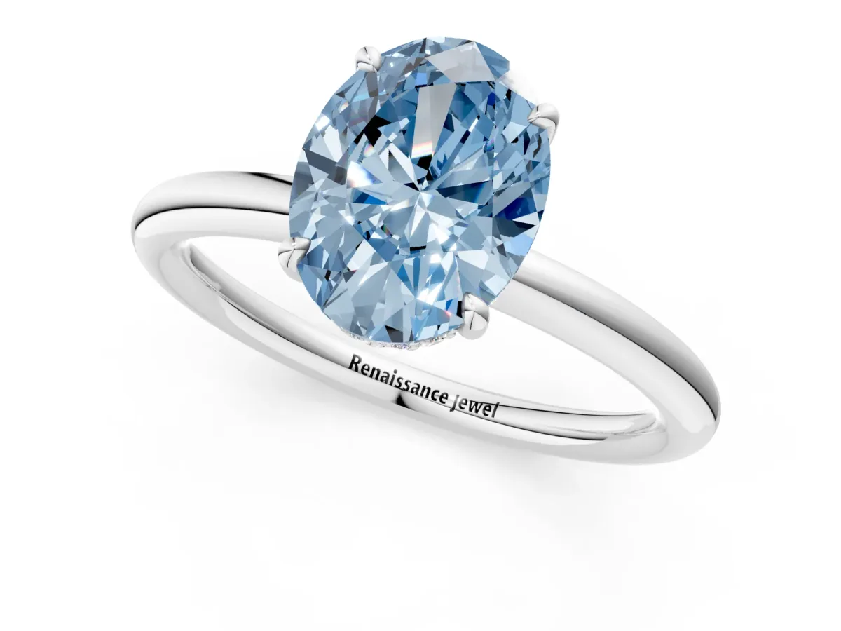 Fancy Blue Oval Cut Diamond Solitaire Ring with Thin Band and Four-Prong Setting White gold