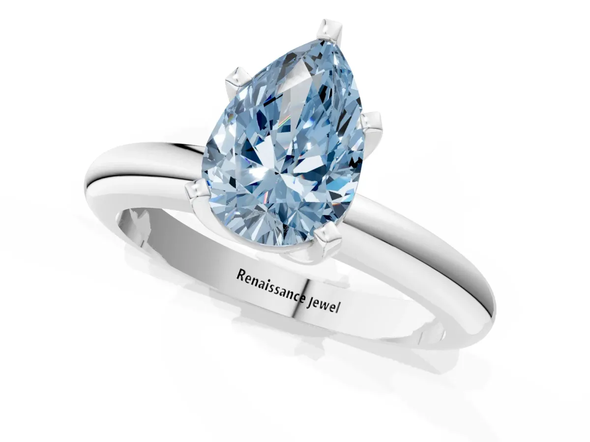Fancy Blue Pear Cut Diamond Solitaire Engagement Ring with Round Band and Four-Prong Setting Silver