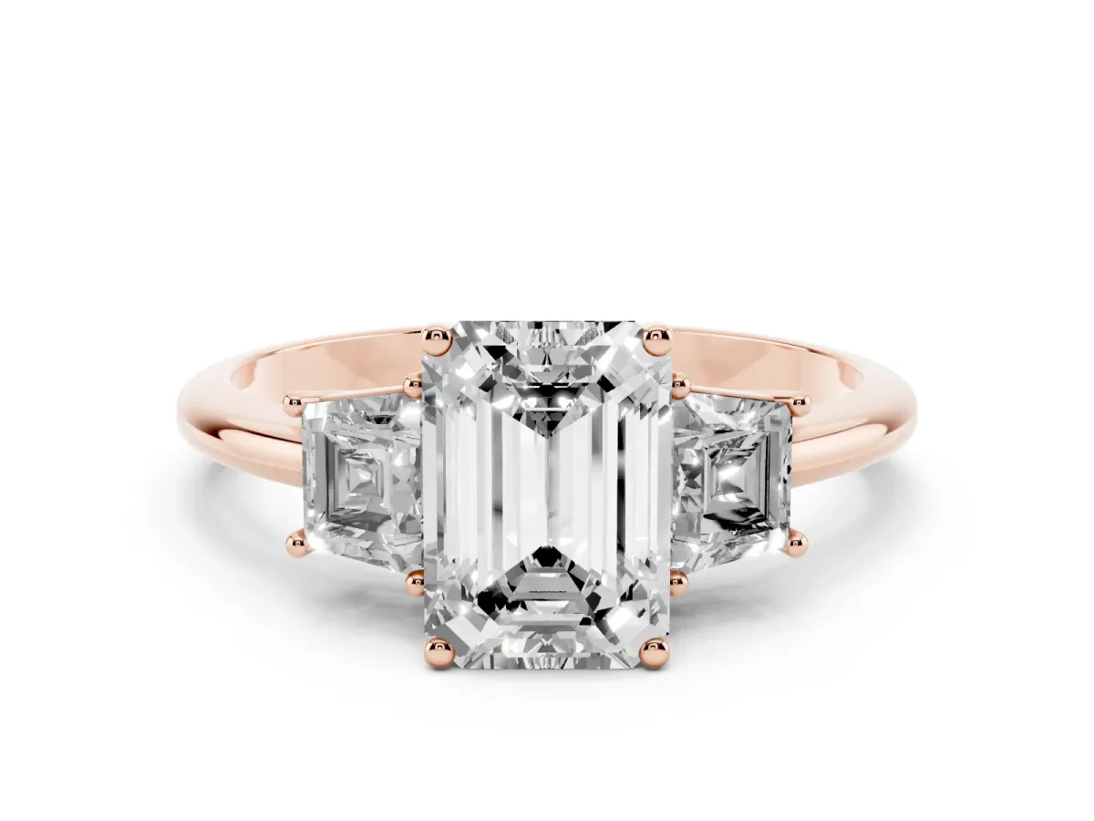 Emerald Cut Diamond Three-Stone Ring with Trapezoid Side Stones and Prong Setting Rose gold