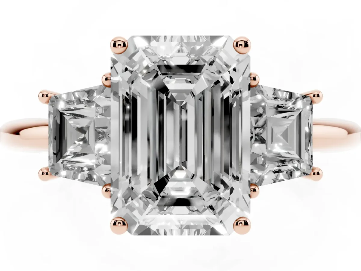Emerald Cut Diamond Three-Stone Ring with Trapezoid Side Stones and Prong Setting Rose gold
