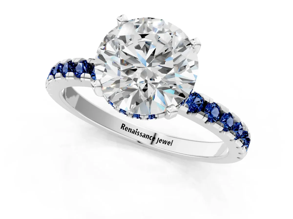 Round Cut Diamond Solitaire Ring with Round Blue Sapphire Pavé Band and Four-Prong Setting Silver