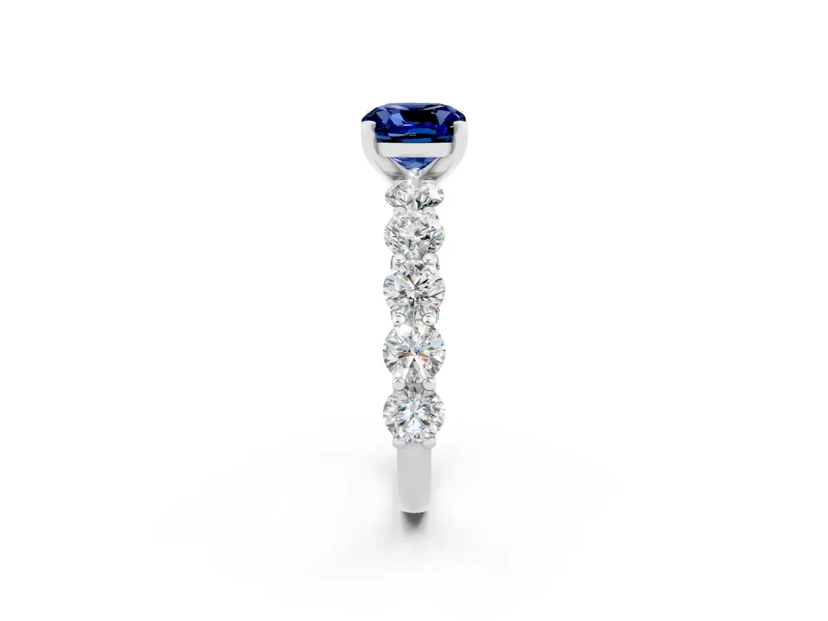 Cushion Cut Blue Sapphire Prong Setting with Side Stones on a Pave Band Silver