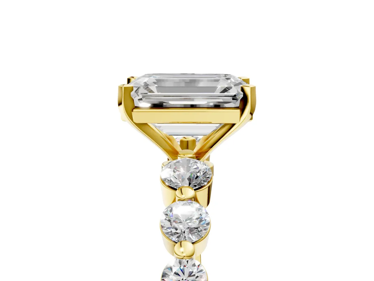Emerald Cut Solitaire Diamond Ring with Pave Band and Four-Prong Setting Yellow gold