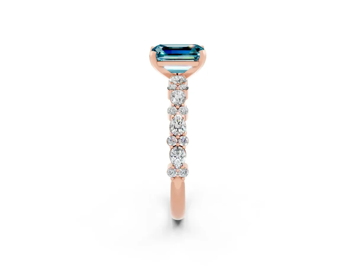 Emerald Cut Blue Topaz Side Stone Solitaire Ring with Round and Four-Prong Setting Rose gold