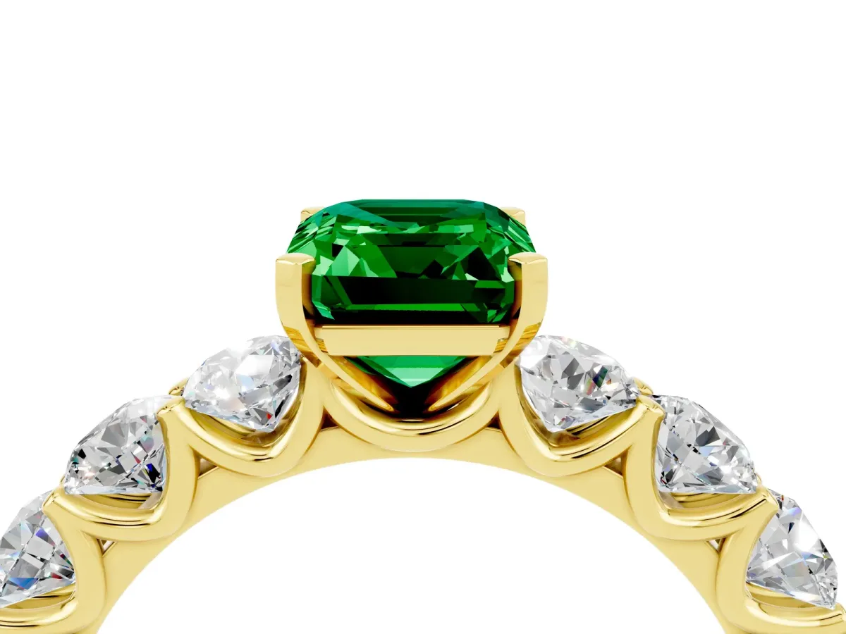 Emerald Cut Emerald Prong Setting with Side Stones on a Pave Band Yellow gold