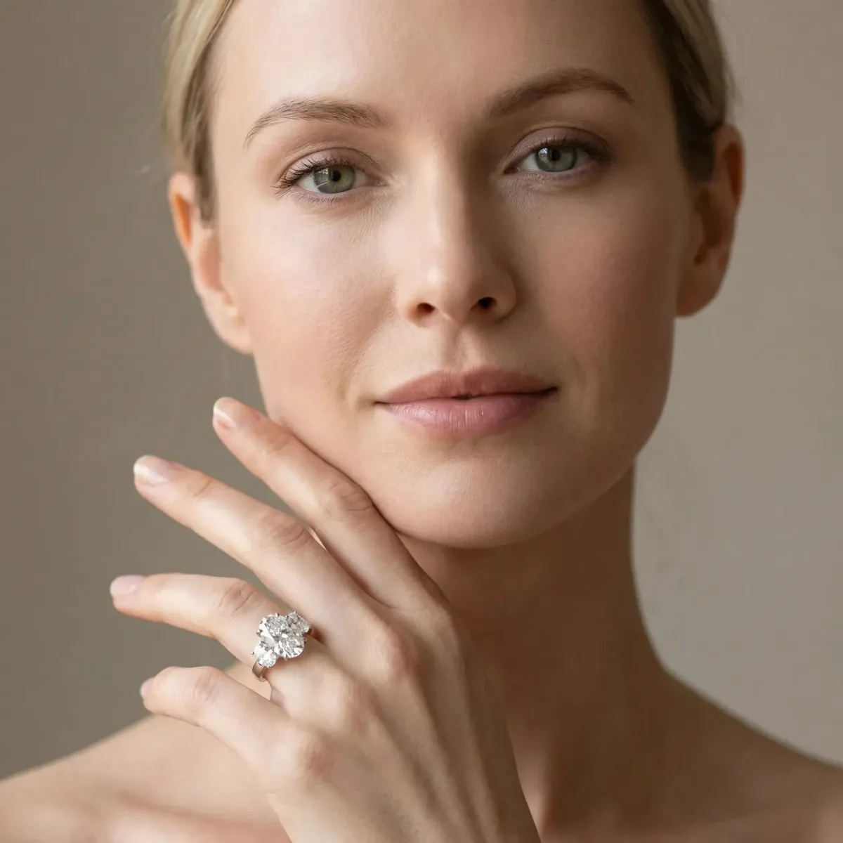 Three-Stone Oval Cut Cut Diamond Ring with Channel Set Band and Four-Prong Setting Platinum
