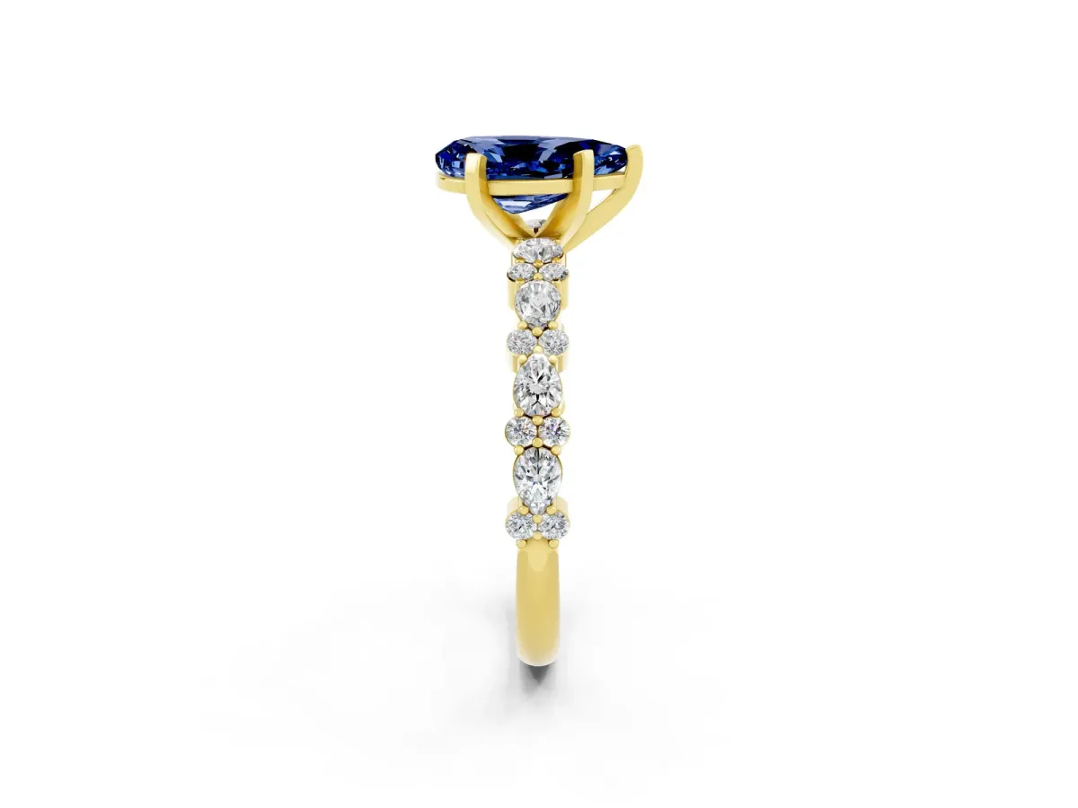 Pear Cut Blue Sapphire Side Stone Solitaire Ring with Round and Four-Prong Setting Yellow gold